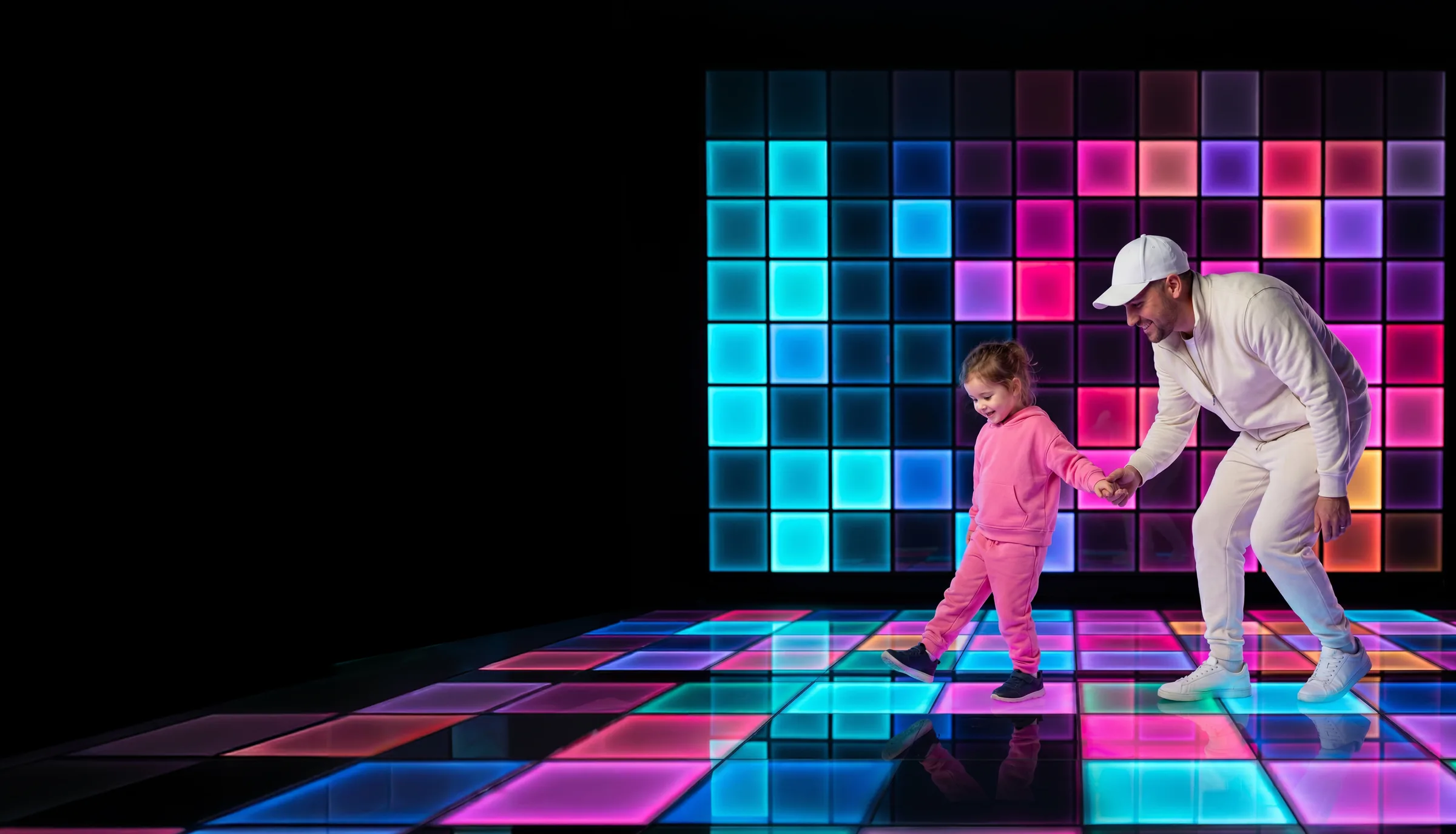 A father and daughter playing on the Pixel Rooms LED floor